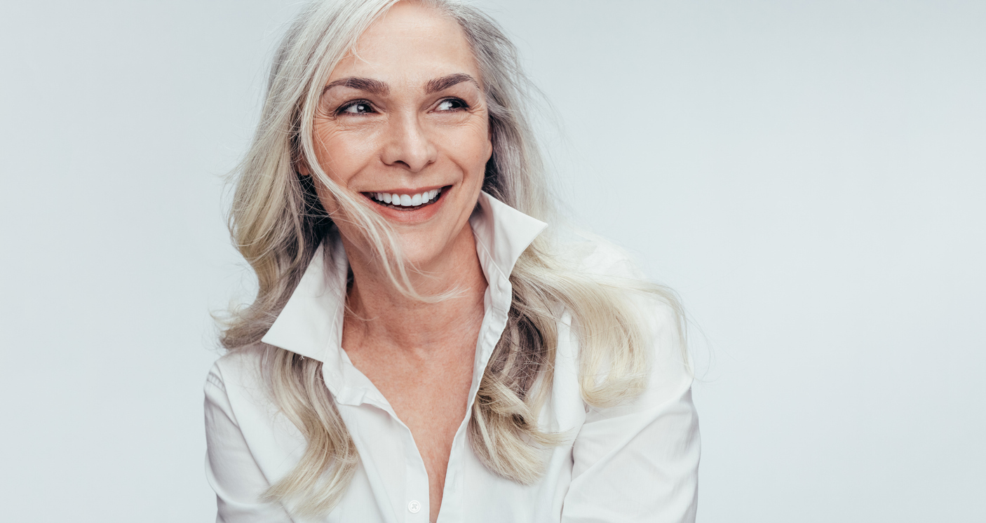Smiling woman with long silver hair